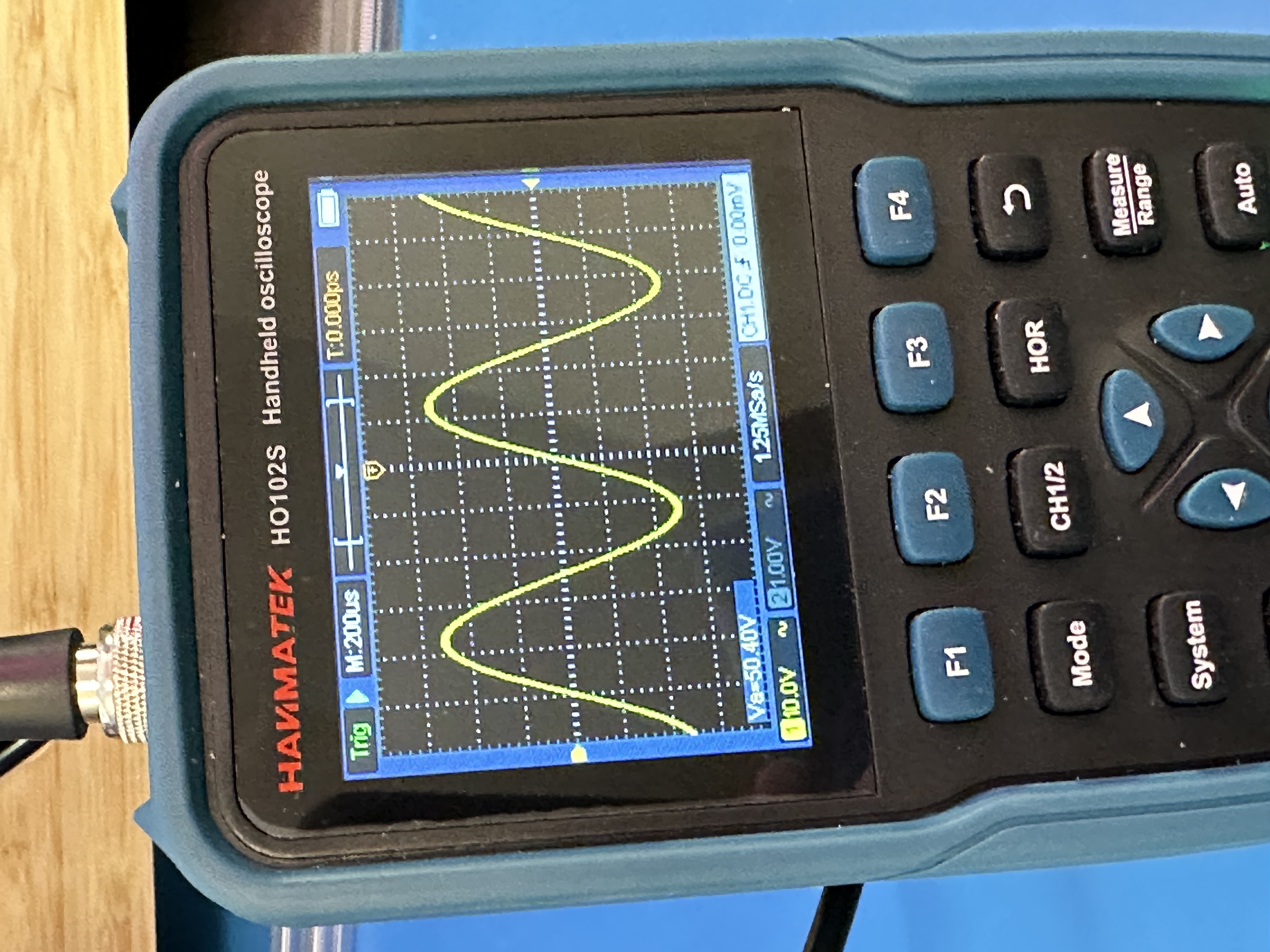 close-up of the multimeter's top half, showing a fairly standard oscilloscope screen