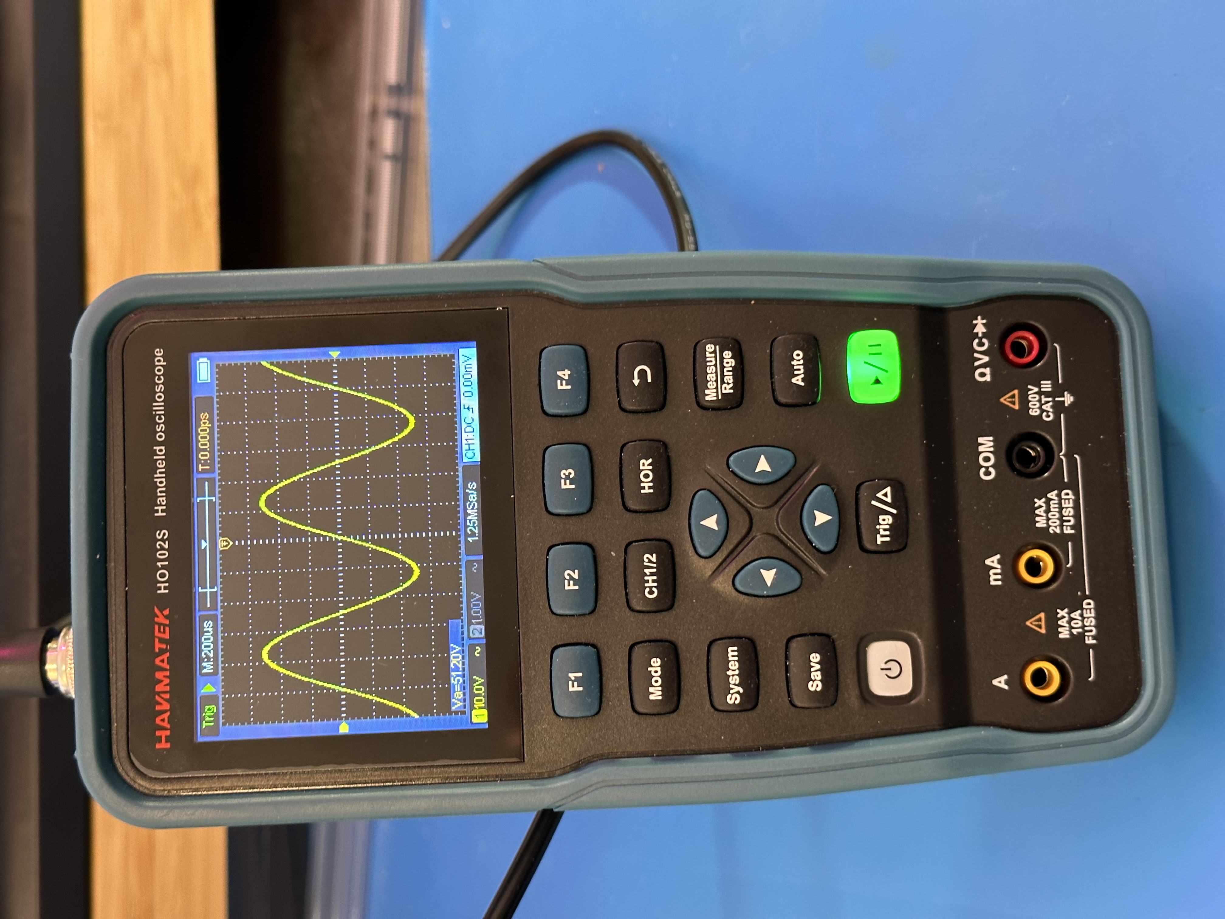 an image of a device in the form factor of a digital multimeter, but with a directional pad and a set of buttons, instead of either a DMM or a scope interface